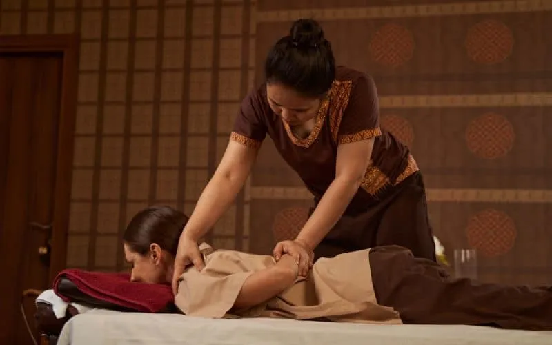 In questa foto vediamo una massaggiatrice svolgere i massaggi thai